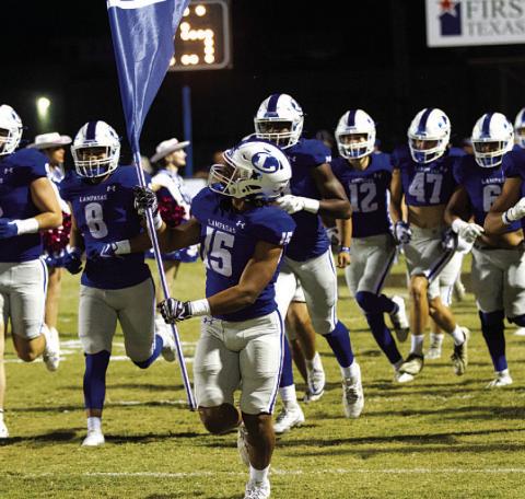 HUNTER KING | DISPATCH RECORD Dailan Fagan leads the Badgers onto the field before every game.