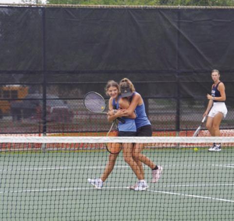 Madelynn White is hugged by her sister Caroline White after the duo won the regional tournament last week. COURTESY PHOTO | KENNETH PEISER