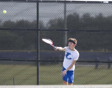 Clayton Shaw follows through on a serve during a previous match for the Badger tennis squad. HUNTER KING | DISPATCH RECORD