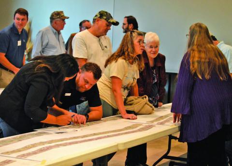 Lampasas County residents chat with TxDOT officials during Tuesday night’s open house to discuss plans for the expansion of U.S. Highway 281 from Lampasas to Evant. ERICK MITCHELL | DISPATCH RECORD