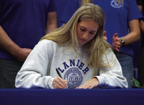Breana Pelbath signs her letter of intent to Lander University. HUNTER KING | DISPATCH RECORD
