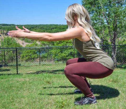 The basic air squat should be conducted with feet shoulder-width apart. Maintain neutral spinal posture in this movement. COURTESY PHOTO