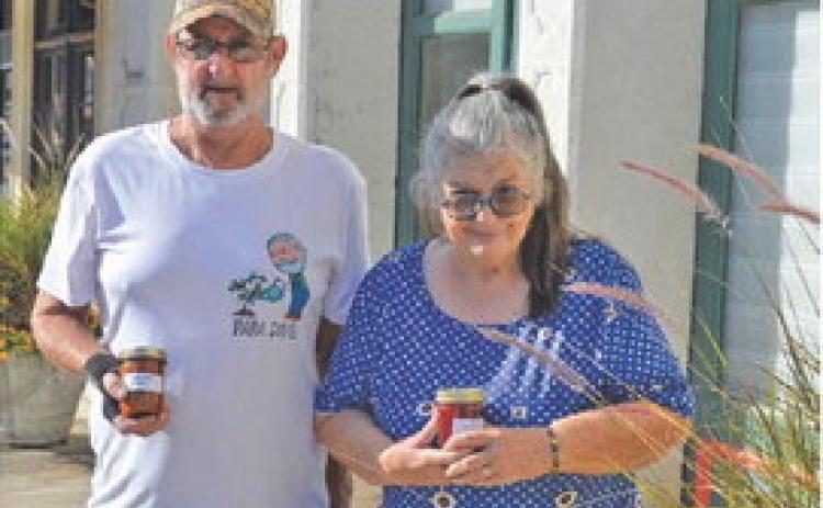 Ruth and David Somers hold up jars of their strawberry fig jam and zucchini salsa. erick mitchell | dispatch record