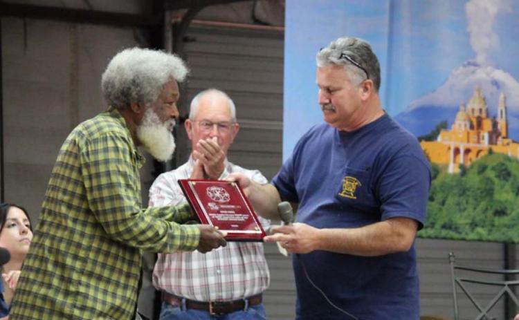 At last year’s barbecue and auction, Kempner Volunteer Fire Department Chief Dan Hause, right, presented an award to Otho King for many years of assisting with the fundraiser. FILE PHOTO
