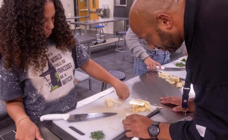 Chef Jason Walsh instructs Brigae Wooten on proper culinary presentation techniques. MICHAEL CUVIELLO | DISPATCH RECORD