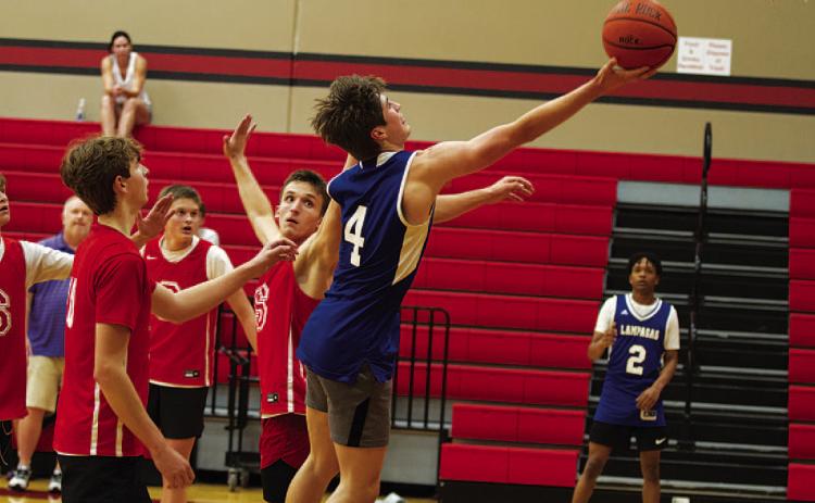 Calum Mitchell lays a ball off the glass during the Badgers’ summer league game against Salado on Wednesday. HUNTER KING | DISPATCH RECORD