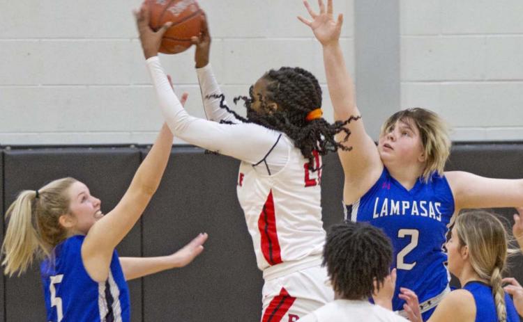 Laurcy Bender (5), Morgan Lovejoy (2) and Payton Tatum (far right) defend against Texas A&amp;M signee Eriny Kindred in a 64-32 win over Del Valle on Friday. JEFF LOWE | DISPATCH RECORD