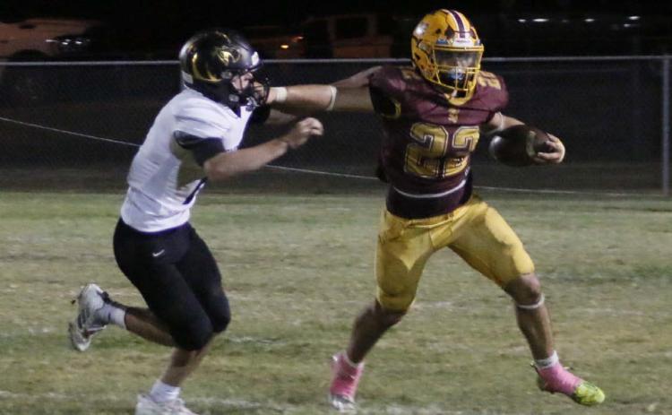 Lukas Smailus-Cruz stiff arms a defender during a run. MASON HINES | DISPATCH RECORD