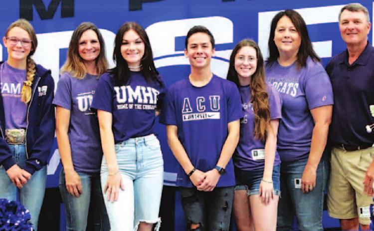 April Smith, left center, and Sam Zmolik, right center, pose with their families. CHRIS MILES | COURTESY PHOTO