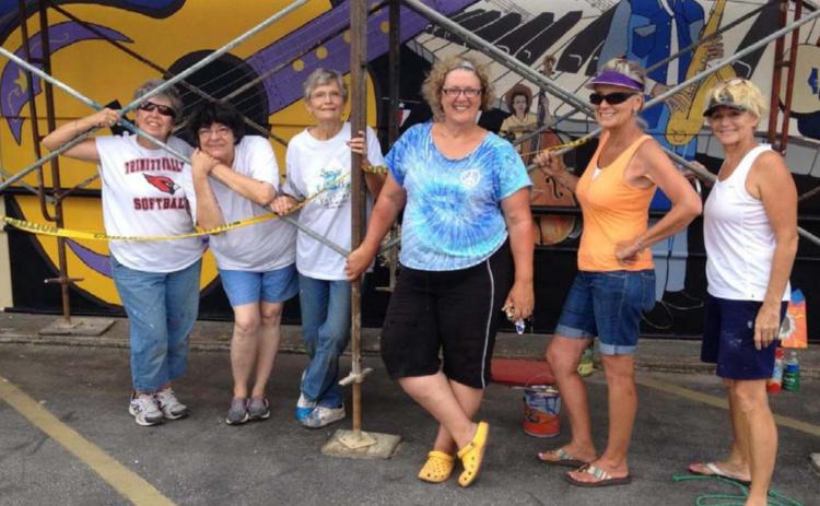 Vision Lampasas members pose for a picture as they paint “Small Town . . . Big Sound.” COURTESY PHOTO
