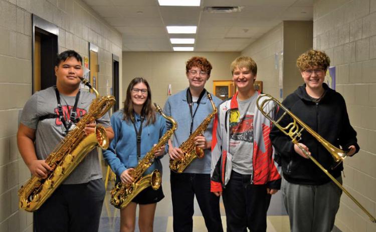 erick mitchell | dispatch record Band members, from left, Sasa Soki, Maddi Griffin, Jacob Whaley, Alexander Thorne and Charlie Pekins pose with their instruments. All five placed in the top 12 for the state jazz band competition with their respective instruments.