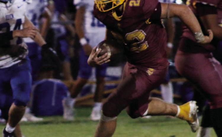 MASON HINES | DISPATCH RECORD Lukas Smailus-Cruz (22) looks for space during a hard run. Smailus-Cruz led the Hornets in rushing with 178 yards and three scores.