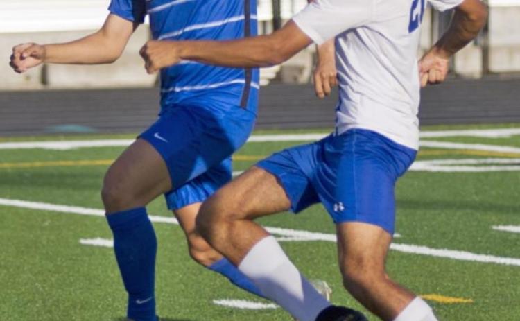 Andrew Grant (21) scores the Badgers’ first goal in the opening minutes of Friday’s bi-district match against Robinson. JEFF LOWE | DISPATCH RECORD