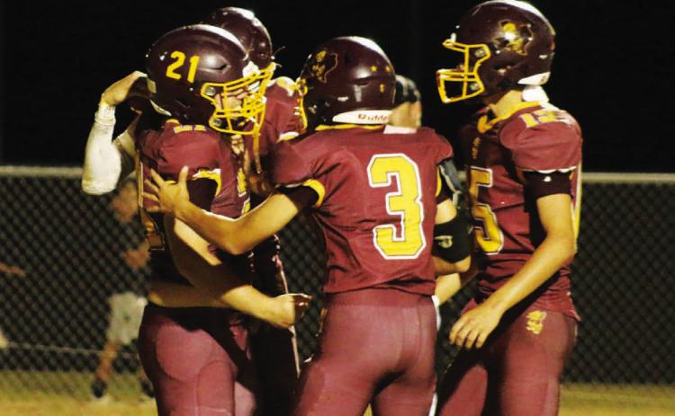 Lometa quarterback Jordan Livesay (3) and running back Carson Brister (15) celebrate in the end zone following Roy Carr’s (21) touchdown reception for the Hornets. MASON HINES | DISPATCH RECORD