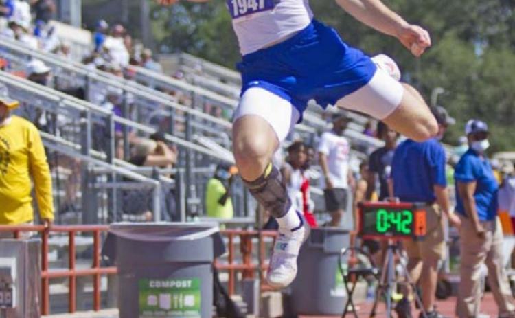 Badger senior Cade White competes in long jump at state on Thursday in Austin. JEFF LOWE | DISPATCH RECORD