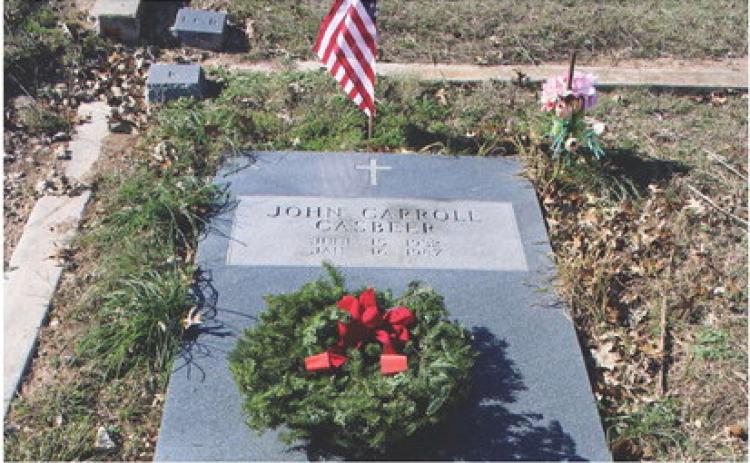 Balsam wreaths such as this one on the grave of John Carroll Casbeer are placed during Wreaths Across America observances in remembrance of those who served to protect freedom and liberty. GREG SMITH | COURTESY PHOTO