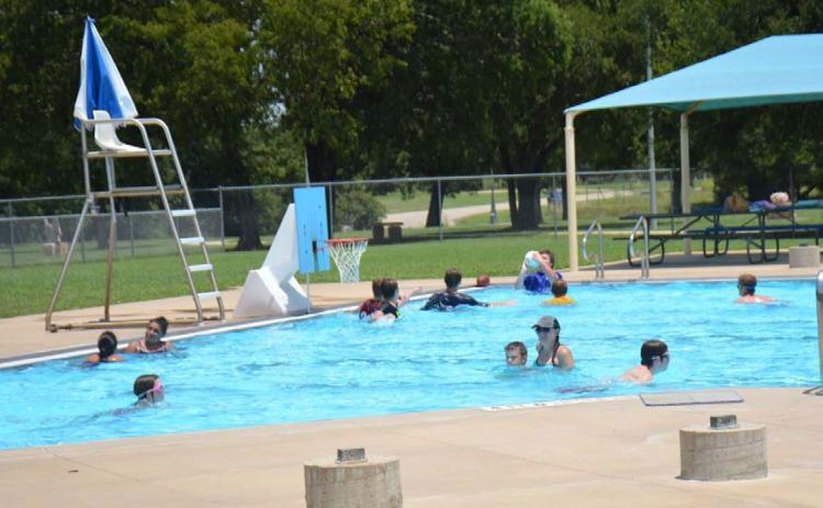 Swimmers of all ages cool off during a hot July at the Hanna Springs Pool. Upcoming events at the pool include the annual Dive-In Movie night and a Teen Scene social event. FILE PHOTO | DISPATCH RECORD