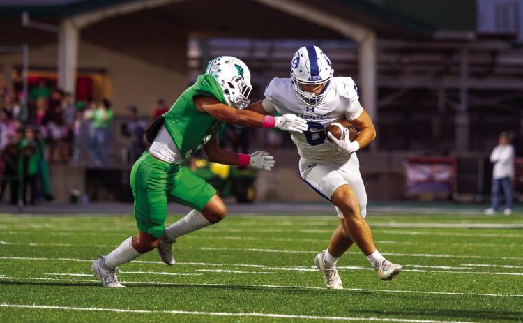PHOTO BY ANA SOFIA MEYER | DISPATCH RECORD Lampasas junior wide receiver Brayden McLoughlin fends off a tackle and cuts up field against Burnet.
