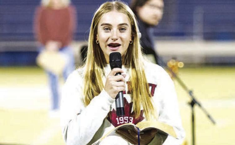 Lampasas high schooler Loretta Hodges reads from the Bible during last week’s Fields of Faith event. HUNTER KING | DISPATCH RECORD