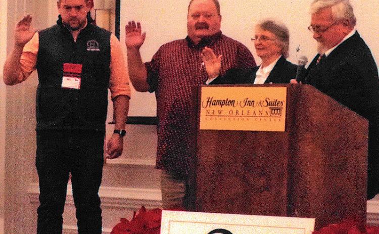 Clovia Ketchum, second from right, is sworn in as president of the National Young Farmers Education Association. Also installed were, from left, James Wood of Indiana, secretary; and Rusty Tipton of Kentucky, president-elect. Handling the officer installation is Donnie Carter of Georgia, past president of NYFEA. courtesy photo