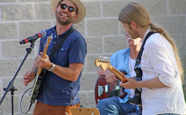 Cord Jackson, at right, performs a solo number while Zach Huckabee accompanies on guitar during the Tuesday night Hayloft Party. mason hines | dispatch record