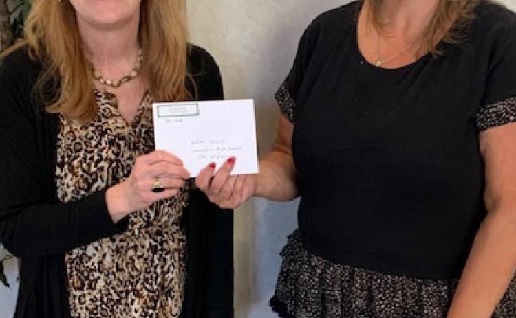 Julie Salvato, coordinator of Career and Technical Education for the Lampasas school district, accepts a check from ’36 Club President Danielle Shepard. COURTESY PHOTO