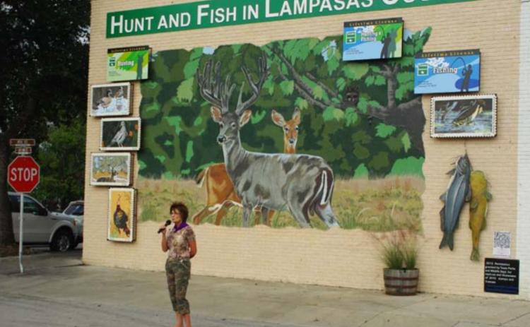 Vision Lampasas member Libby Bluntzer speaks at the 2012 unveiling of the organization’s “Hunt and Fish in Lampasas County” mural. BILL MCDONALD | COURTESY PHOTO