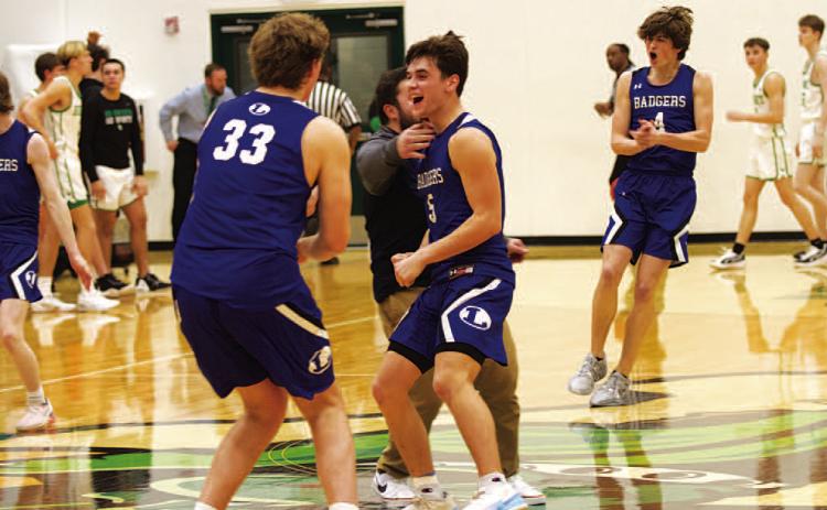 Beau Patterson (33), Trent Seneca (5) and the Badger team celebrate after beating Burnet on the road on Tuesday night. HUNTER KING | DISPATCH RECORD