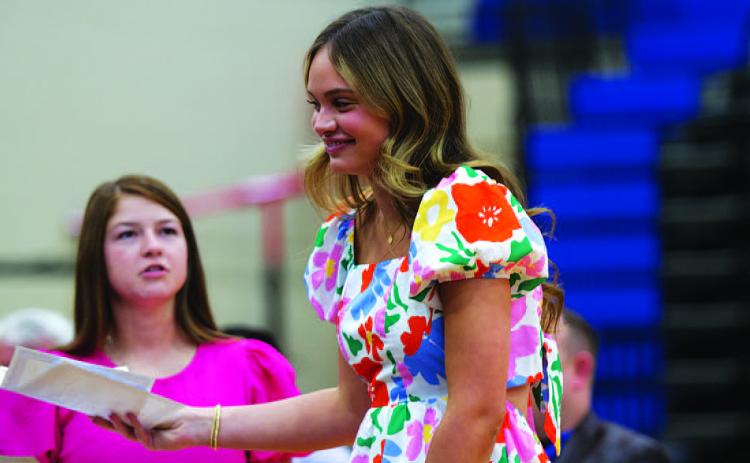 Morgan Bobo receives her award at Wednesday night’s basketball banquet in the high school gym. HUNTER KING | DISPATCH RECORD