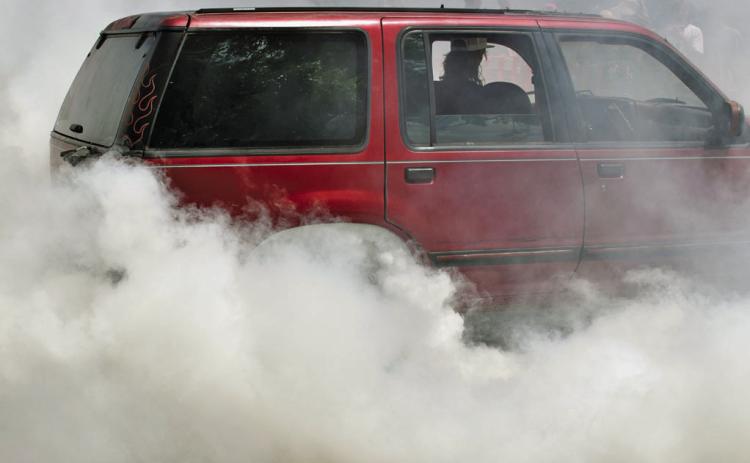 Smoke from the burnout competition is thick enough to obscure the cars competing. JOSEPH NEUENSCHWANDER | DISPATCH RECORD