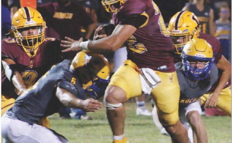 Lukas Smailus-Cruz rumbles through two Rochelle defenders. Smailus-Cruz had 357 yards and five touchdowns in Friday’s contest. MASON HINES | DISPATCH RECORD