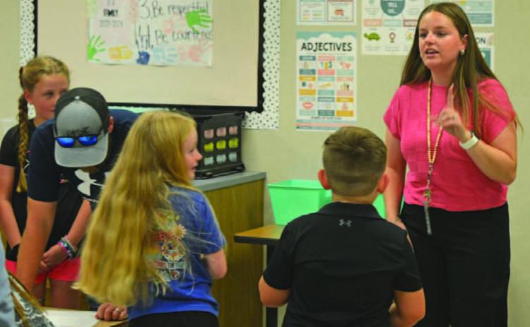 Hanna Springs Elementary School second-grade teacher Taylor Richard welcomes students to their new classroom. ERICK MITCHELL | DISPATCH RECORD