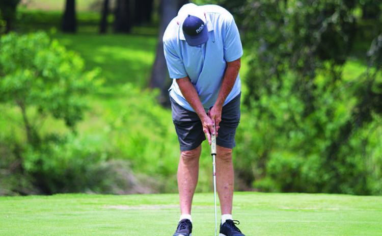 HUNTER KING | DISPATCH RECORD Ron Acker hits a short par putt during day two of the tournament on Sunday.