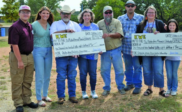 Kline Whitis Elementary School students raised more than $3,900 for the Peyton Jones Memorial Scholarship and the Michael January Memorial Scholarship. Pictured at left are second-grade teacher Amy Brown and her family, representing the January scholarship, and Shante Seward, second from right, with her family, representing the Jones scholarship. ERICK MITCHELL | DISPATCH RECORD