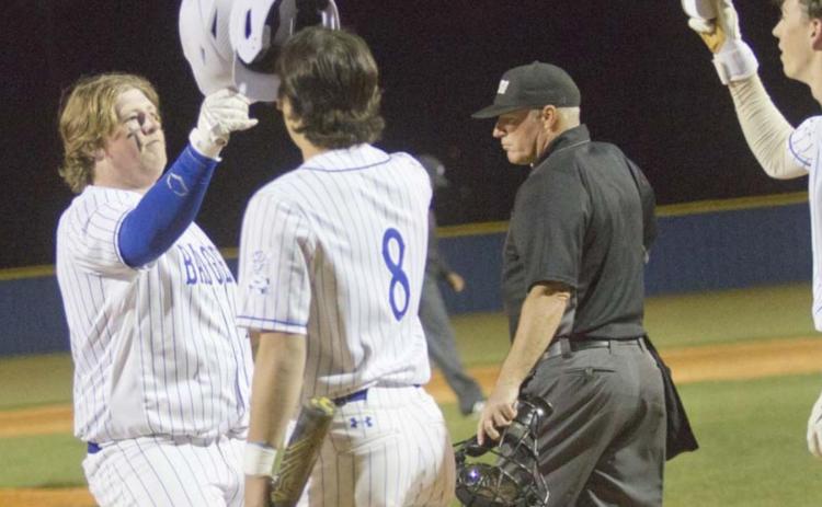 First baseman Hayden Waldrip, left, Tak Stinnett and other teammates celebrate Waldrip’s three-run homer in the seventh inning. That shot cut the Hornets’ lead down to one run, but Gatesville still defeated Lampasas. JEFF LOWE | DISPATCH RECORD