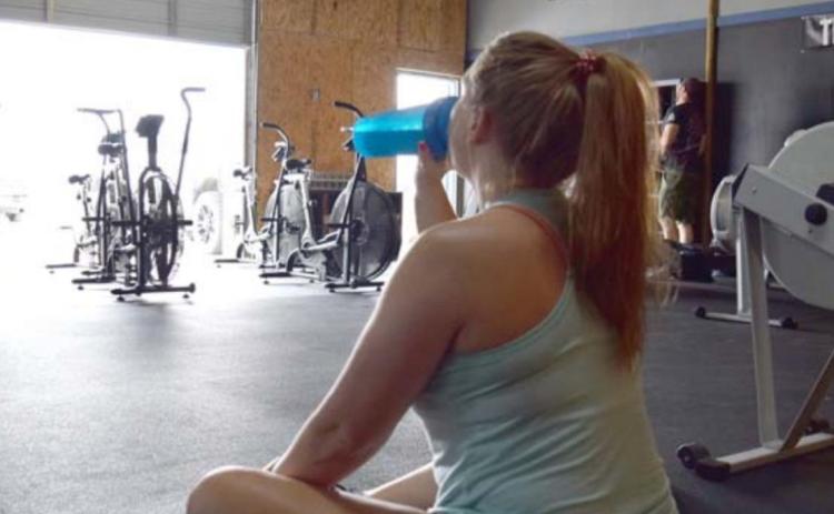 An athlete hydrates before a training session in an open-air gym on a hot afternoon. ALEXANDRIA RANDOLPH MURRELL | COURTESY PHOTO