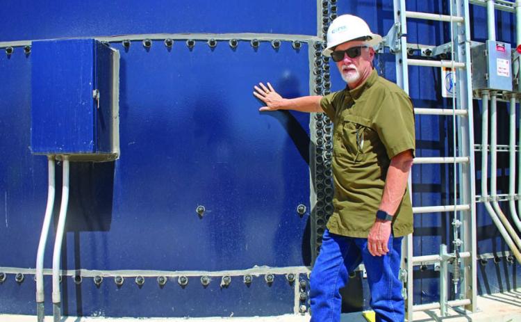 Darrin Barker highlights the use of Corix’s “clear well,” a glass-insulated container that stores clean, filtered water at the plant. MASON HINES | DISPATCH RECORD