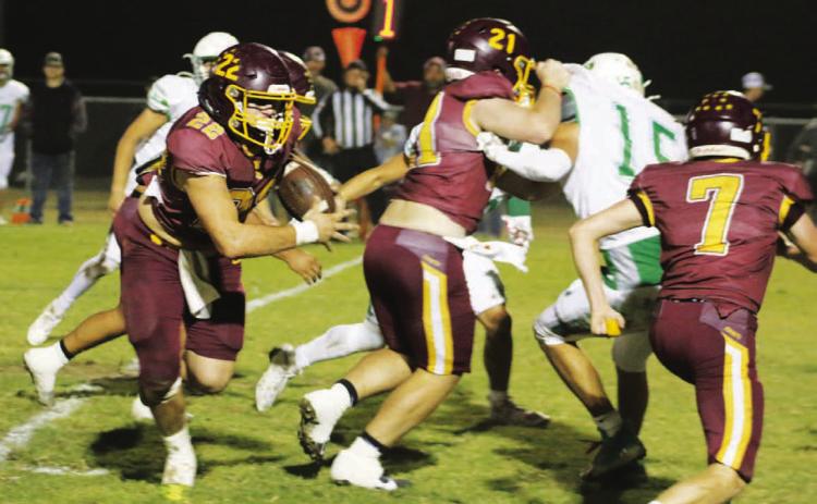 Lukas Smailus-Cruz looks for running room while Roy Carr (21) and Easton Hamilton (7) block. Smailus-Cruz rushed for three touchdowns in the game. MASON HINES | DISPATCH RECORD