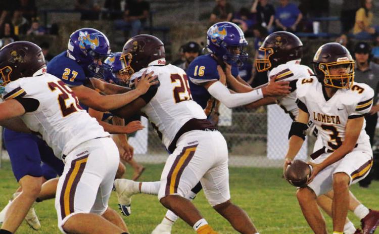 Jordan Livesay pitches the ball behind Lometa’s offensive line of, left to right, Roy Carr, Emmanuel Prado and Colten Whitehead. MASON HINES | DISPATCH RECORD