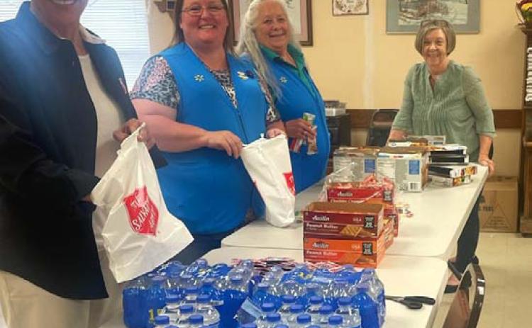 Salvation Army volunteers work with Walmart employees to prepare snack bags for first responders who were on call during the total solar eclipse. courtesy photo