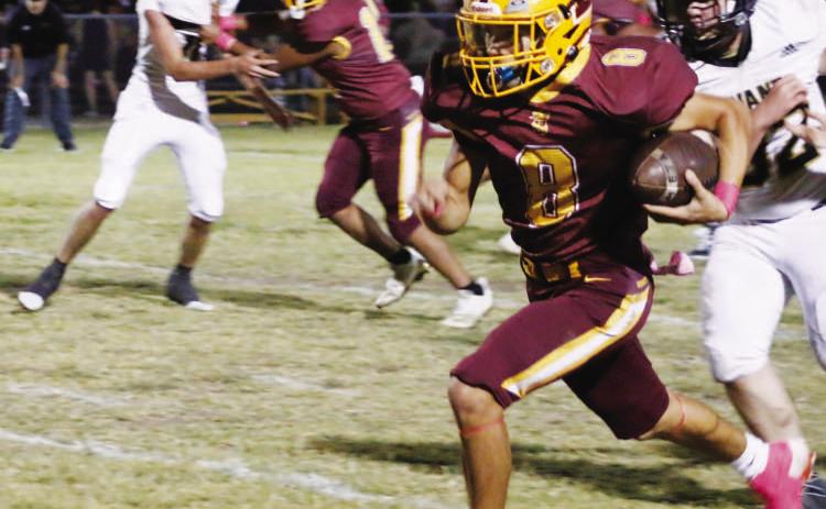 MASON HINES | DISPATCH RECORD Senior Brandon Moore looks for room to accelerate during one of his two touchdown runs in Friday’s 60-14 win over Evant.