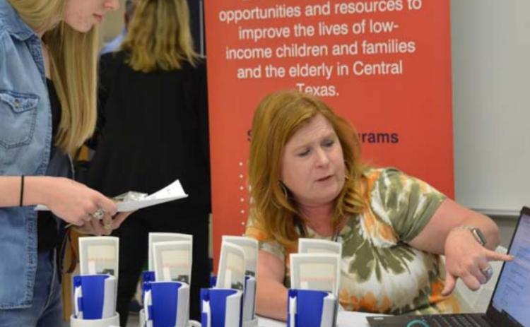 Marlee Hyatt, left, goes over employment information with Hill Country Community Action HR Specialist Regina Baker at last year’s Lampasas Economic Development Corp. job fair. FILE PHOTO