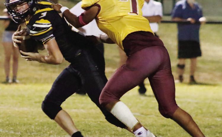 Leonel Caso wrangles a Jonesboro runner during Friday’s contest. MASON HINES | DISPATCH RECORD