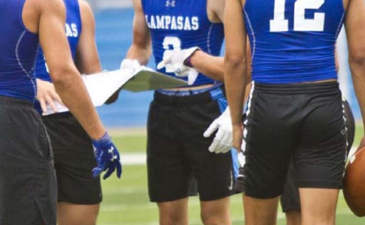 Badger players, left to right, Aden Rascoe, Dax Brookreson, Owen Stubbs, Ethan Moreno and Dylan Sanchez look at plays in the huddle at a 7-on-7 game last week in Georgetown. JEFF LOWE | DISPATCH RECORD e, Dax Brookreson,