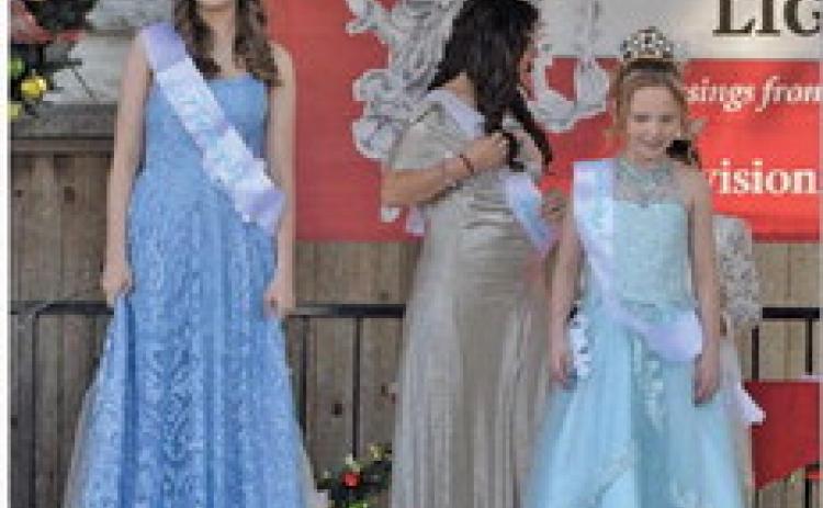 ERICK MITCHELL | DISPATCH RECORD At left, Caroline Claude and Jessi Fields receive their sashes to designate them Snow Princess and Snow Queen, respectively.