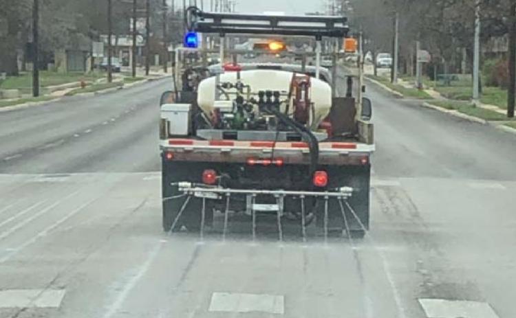 A Texas Department of Transportation truck applies brine to a highway surface. The water-salt mixture creates a barrier that helps prevent ice from bonding with the roadway. COURTESY PHOTO