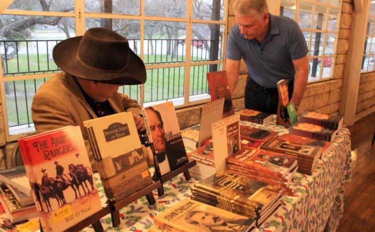 Historian Bill O’Neal, at left, is shown at a March 2020 Daughters of the Republic of Texas event at the Hostess House during which he signed books and spoke on the Texas Rangers in film. O’Neal will return to Lampasas March 7 for a presentation on World War II hero Audio Murphy. FILE PHOTO