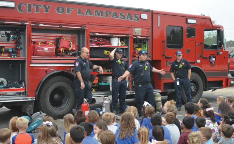Lampasas Fire Department firefighters speak with students about fire safety during last Friday’s Hanna Springs Elementary School Safety Walk event. erick mitchell | Dispatch record