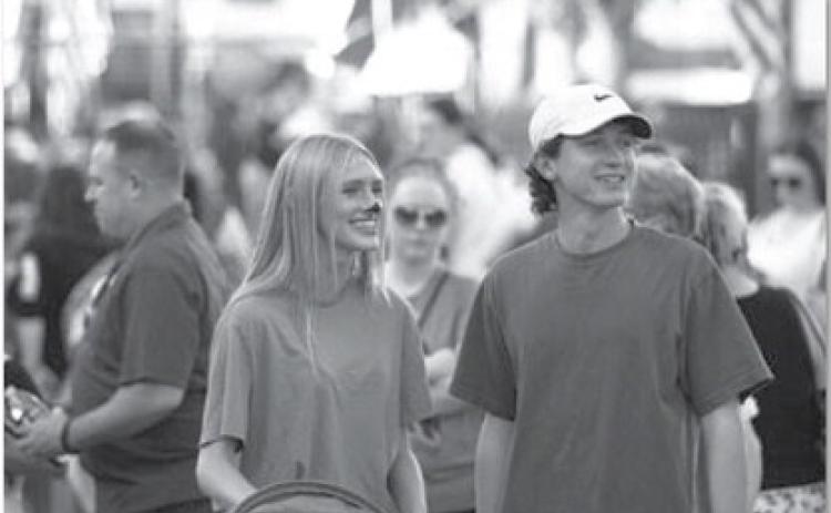 Leah Phillips, left, and Elijah Copeland smile as they walk around the square during the annual Squared Silly event last week. hunter king | Dispatch record