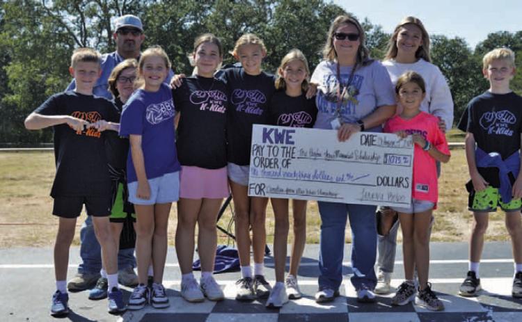 Kline Whitis Elementary School teacher Shante Seward holds a big check for $1,073.62. The funds were raised by Kline Whitis students for the Peyton Jones Memorial Scholarship. Jones, Seward’s son, died after a battle with leukemia several years ago. ERICK MITCHELL | DISPATCH RECORD